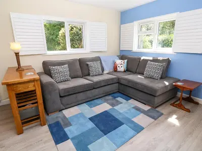 a living room with a couch and a rug at Chy-An-Oula in Falmouth