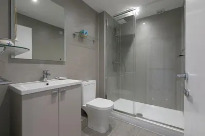 a bathroom with a shower and a toilet and a sink at Chy an Pol in St Ives