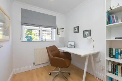 a room with a desk and a chair and a window at Chy an Pol in St Ives