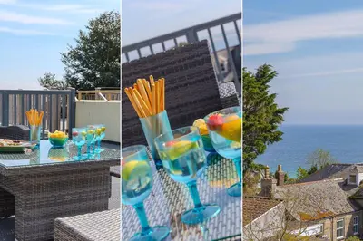 a table with glasses of drinks on a balcony at Chy an Pol in St Ives