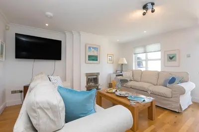 a living room with a couch and a tv at Chy an Pol in St Ives