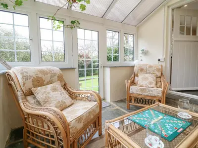 a living room with two chairs and a coffee table at Lower Tamsquite in Bodmin
