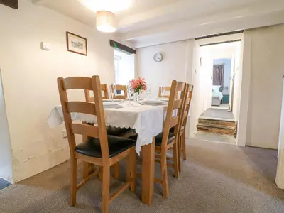 a dining room with a table and chairs at Lower Tamsquite in Bodmin