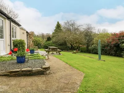a garden with a picnic table and a bench at Lower Tamsquite in Bodmin