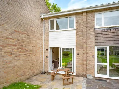a brick house with a patio and a table at Manor Haven - Atlantic Reach in Saint Columb Major