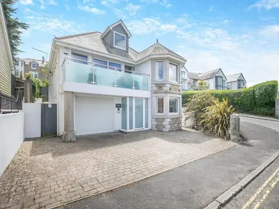 a house with a large garage in front of a street at Chapel View in Carbis Bay