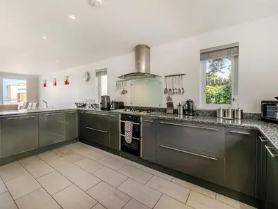 a kitchen with stainless steel cabinets and a stove at Chapel View in Carbis Bay