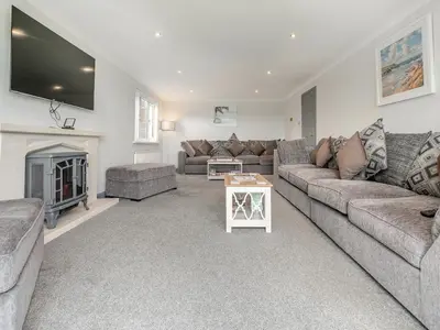 a living room with two couches and a fireplace at The Lodge in Helston