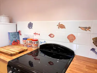 a kitchen with a toaster oven in a kitchen at April Cottage in Tintagel