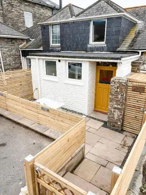a house being built with a wooden fence at April Cottage in Tintagel