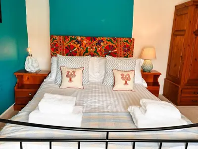 a bed with two pillows on it in a room at April Cottage in Tintagel