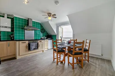 a kitchen with a table and chairs and green tiles at 3 Bed in Looe oc-w29227 in Looe