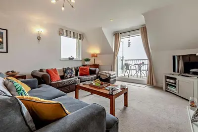 a living room with couches and a table at 3 Bed in Looe oc-w29227 in Looe