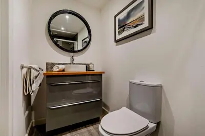 a bathroom with a toilet and a mirror at 3 Bed in Looe oc-w29227 in Looe