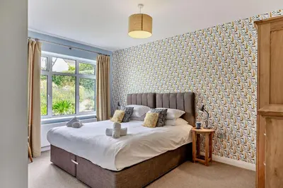 a bedroom with a bed and a large window at 6 Bed in Newquay oc-e18072 in Newquay