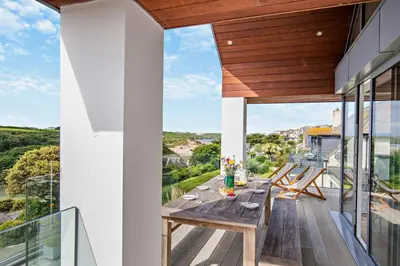 a wooden table on the balcony of a house at 6 Bed in Newquay oc-e18072 in Newquay