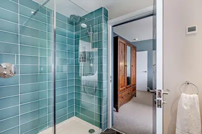 a bathroom with a shower with blue tiles at 6 Bed in Newquay oc-e18072 in Newquay