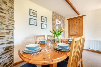 a dining room with a wooden table and chairs at 3 Bed in St. Merryn oc-m29320 in St Merryn