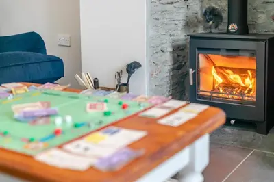 a living room with a table and a fireplace at 3 Bed in Golant oc-o29307 in Golant