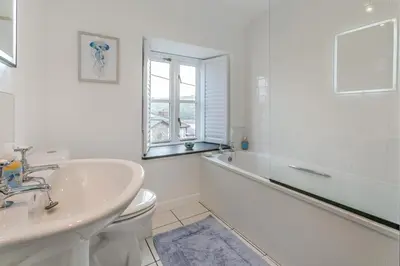 a white bathroom with a sink and a toilet at 3 Bed in Golant oc-o29307 in Golant