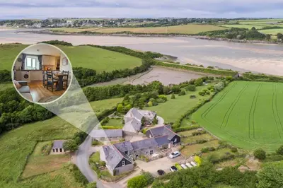 an aerial view of a house on a hill next to a river at 2 Bed in St. Issey oc-t29235 in Saint Issey