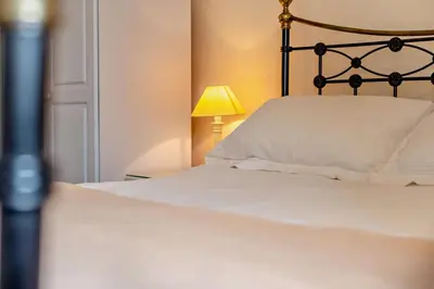 a bedroom with a bed with a lamp and a white pillow at 2 Bed in St. Issey oc-t29235 in Saint Issey