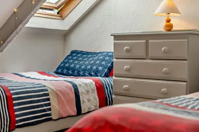 a bedroom with two twin beds and a dresser at 2 Bed in St. Issey oc-t29235 in Saint Issey