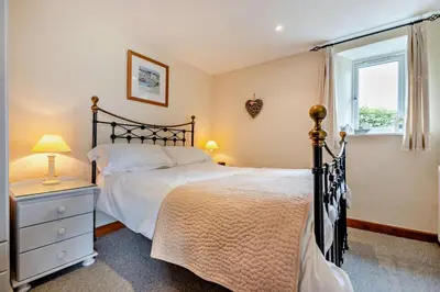 a bedroom with a large bed and a window at 2 Bed in St. Issey oc-t29235 in Saint Issey