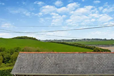 a roof of a house with a green hill in the background at 2 Bed in St. Issey oc-t29235 in Saint Issey
