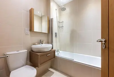 a bathroom with a toilet and a sink and a tub at 4 Fernhill in Carbis Bay