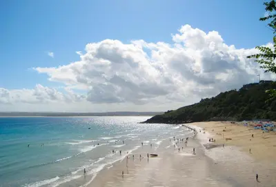 a group of people on a beach near the water at 4 Fernhill in Carbis Bay