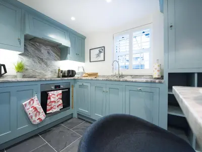 a kitchen with blue cabinets and a sink at Apartment Juliot by Interhome in St Ives