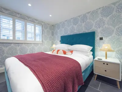 a bedroom with a bed with a red and white blanket at Apartment Juliot by Interhome in St Ives