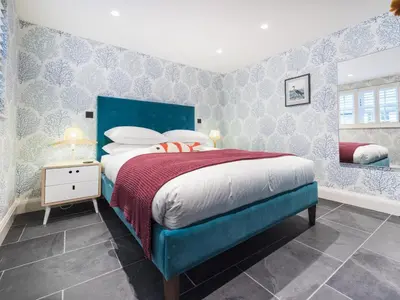 a bedroom with a bed with a blue headboard at Apartment Juliot by Interhome in St Ives