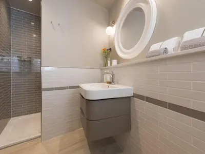 a bathroom with a sink and a mirror and a shower at Holiday Home Wella by Interhome in St Ives