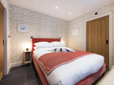 a bedroom with a large bed with white pillows at Holiday Home Wella by Interhome in St Ives