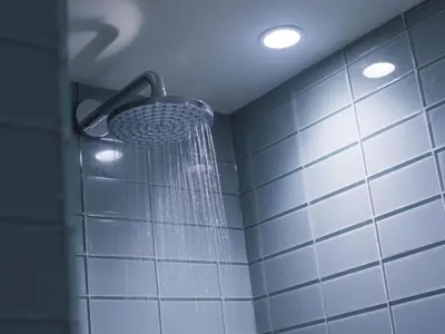 a shower head in a bathroom with blue tiles at Holiday Home Iris by Interhome in St Ives
