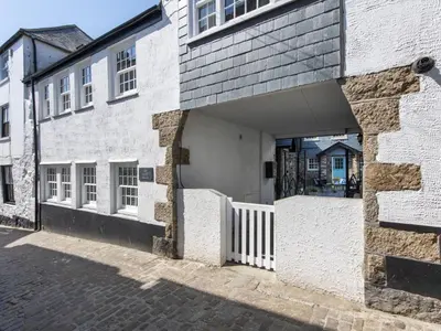 a white brick building with an open garage at Holiday Home Iris by Interhome in St Ives