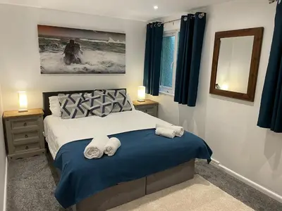 a bedroom with a bed with two towels on it at Claire’s place in Hayle