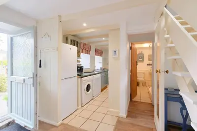 a laundry room with a washer and dryer in a house at Farm Cottage, Chypons Farm, Rural St Ives in Penzance