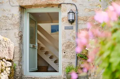 a window of a building with a stairs in it at Farm Cottage, Chypons Farm, Rural St Ives in Penzance