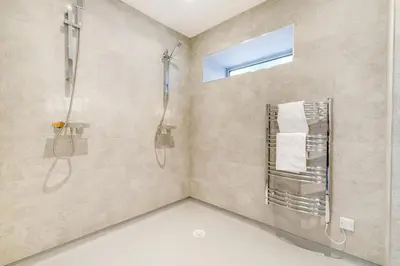 a bathroom with a shower and a sink and a window at 4 Bed in Trevone oc-p28959 in St Merryn