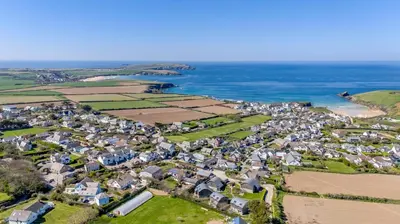 an aerial view of a village next to the ocean at 4 Bed in Trevone oc-p28959 in St Merryn