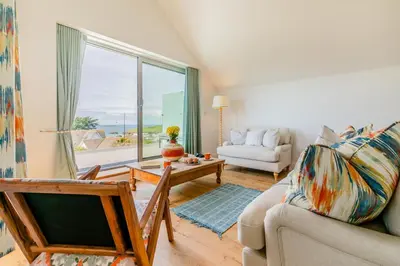 a living room with a couch and a table at 4 Bed in Trevone oc-p28959 in St Merryn