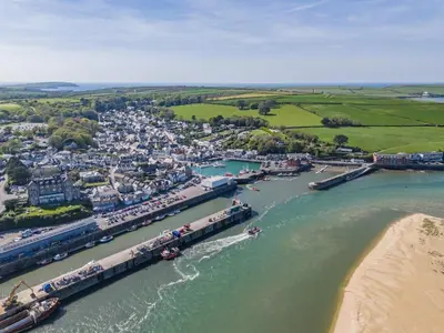 an aerial view of a harbor with a train on a river at 3 Bed in Padstow oc-h28928 in Padstow