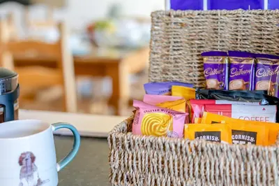 a basket filled with snacks and a cup of coffee at 2 Bed in St. Merryn oc-l29063 in St Merryn