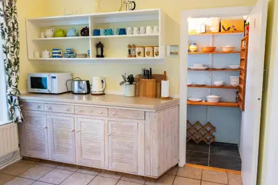 a kitchen with a counter with a microwave at Spectacular Sea View Retreat in Lanteglos