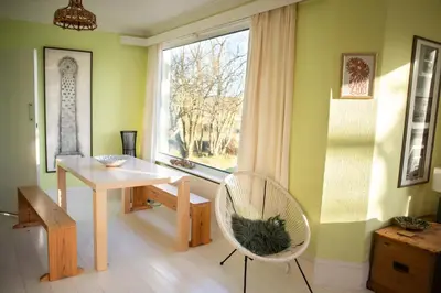 a room with a table and a chair and a window at Spectacular Sea View Retreat in Lanteglos