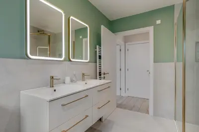 a bathroom with a white sink and two mirrors at 6 Bed in High Lanes oc-r29370 in Little Petherick