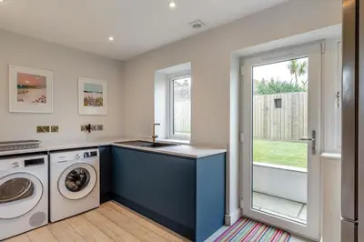 a laundry room with a washer and dryer at 6 Bed in High Lanes oc-r29370 in Little Petherick